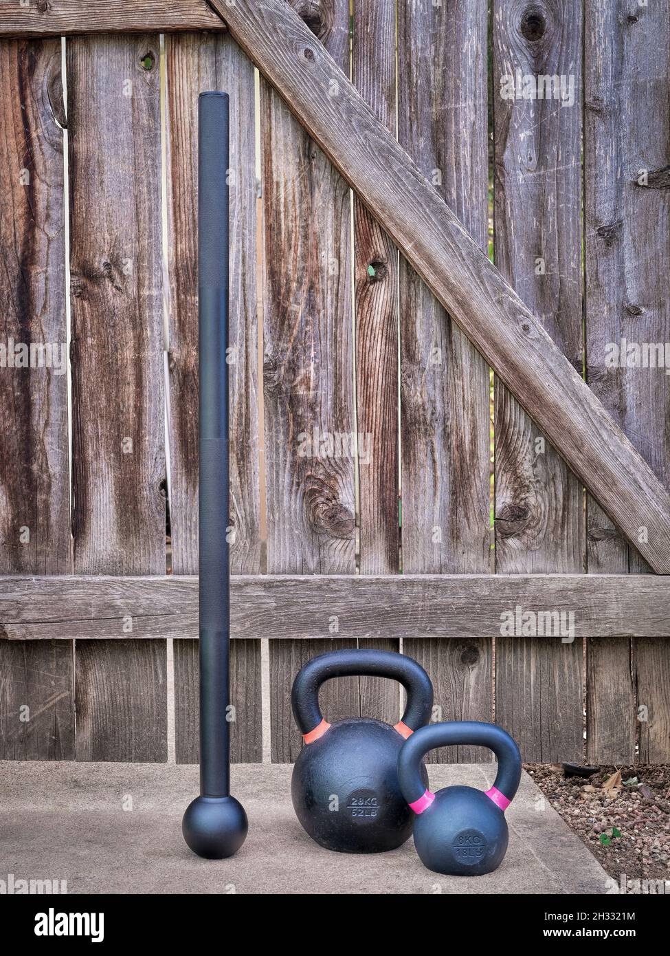 steel mace (macebell) and iron kettlebells against a rustic wooden gate in  a backyard, home functional fitness concept using unconventional equipment  Stock Photo - Alamy