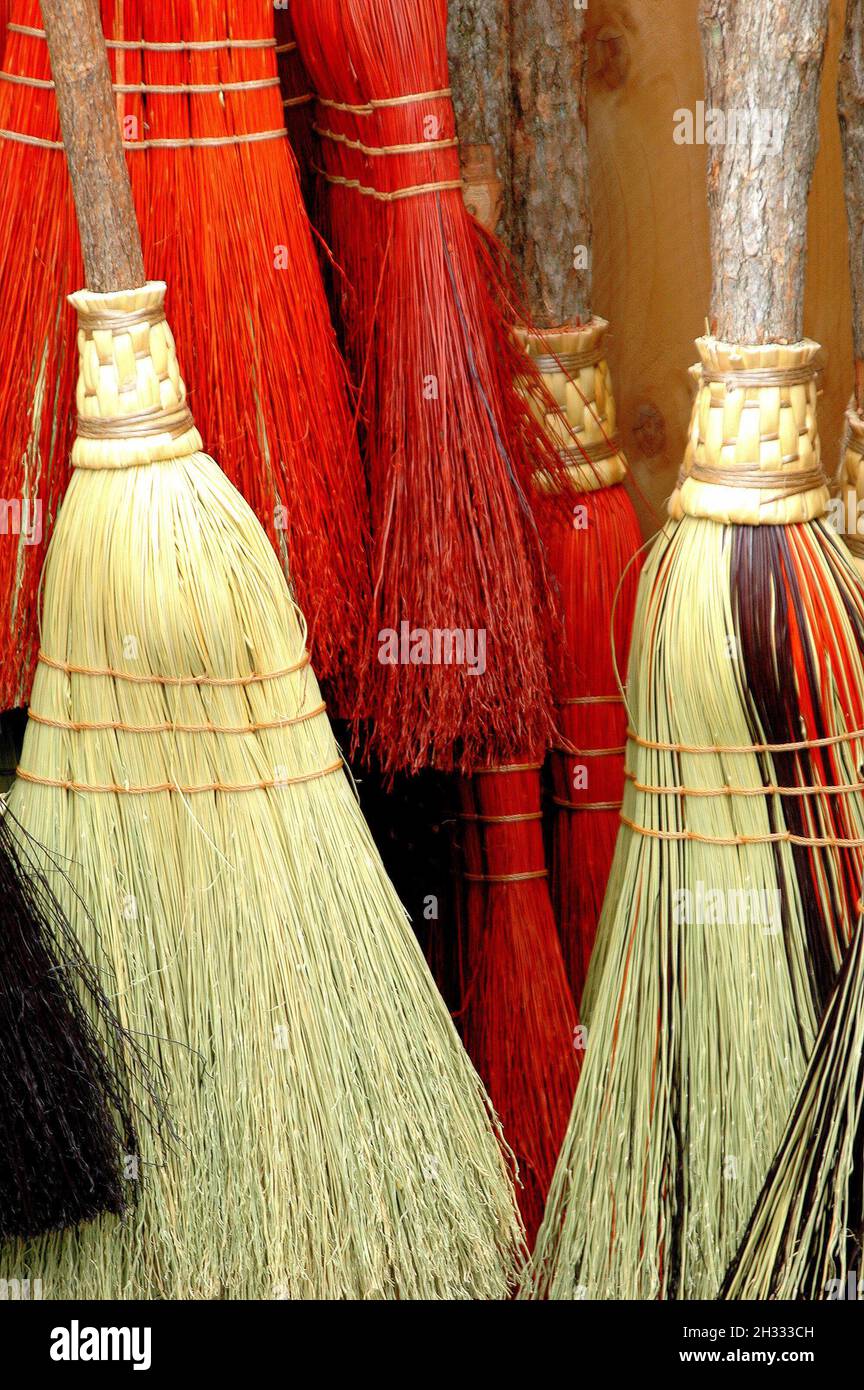 Vertical shot of the colorful brooms Stock Photo