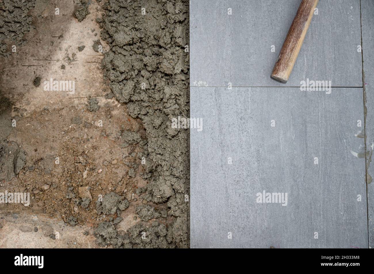 Mallet and tools on granite tile during laying floor Stock Photo