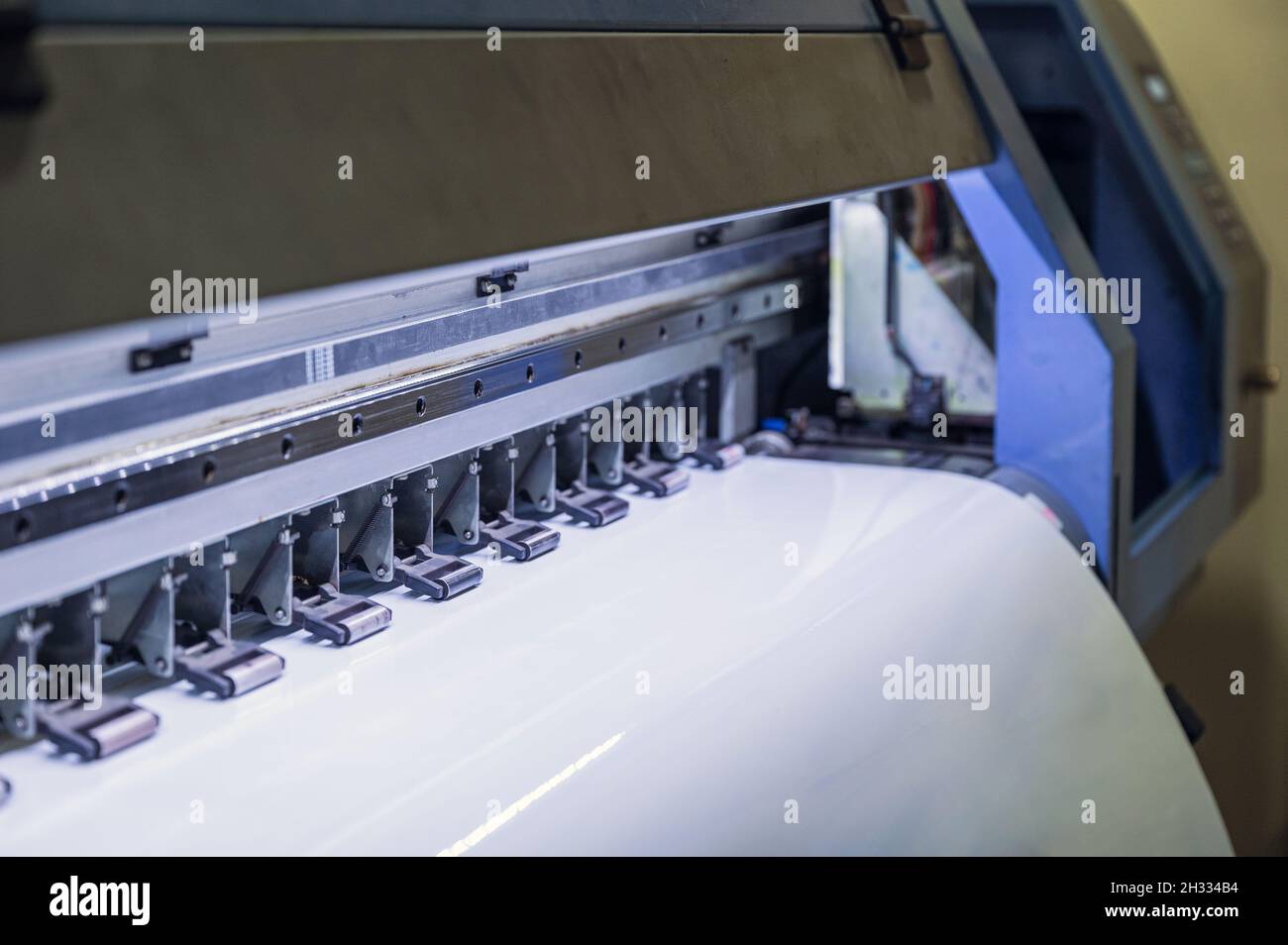 Large inkjet printer printing on vinyl paper in Stock Photo