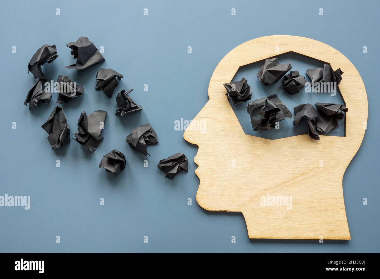 Head shape and black paper balls as negative thoughts. Stock Photo