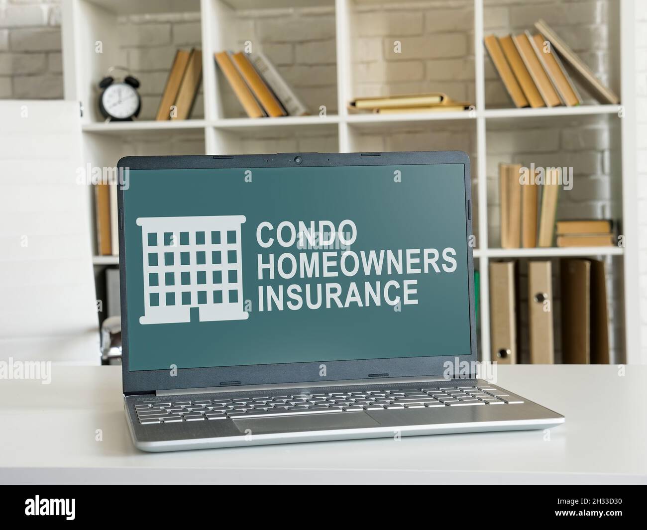 Condo homeowners insurance on the laptop in the office. Stock Photo