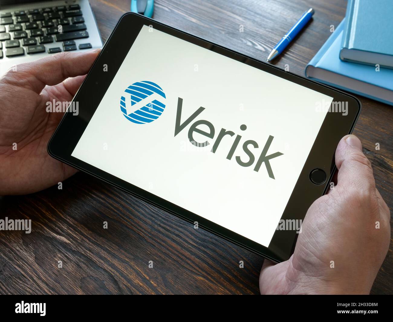 KYIV, UKRAINE - October 20, 2021. Hands holds tablet with Verisk Analytics logo. Stock Photo