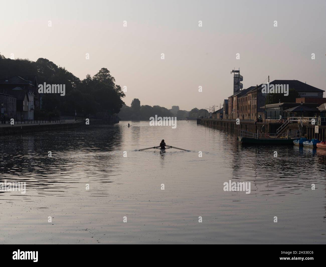 Rowers on River at Dawn Stock Photo