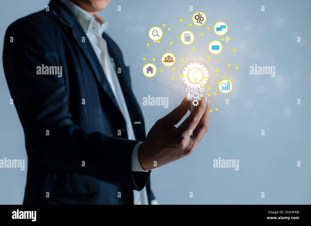 Businessman holding a bright light bulb. Stock Photo