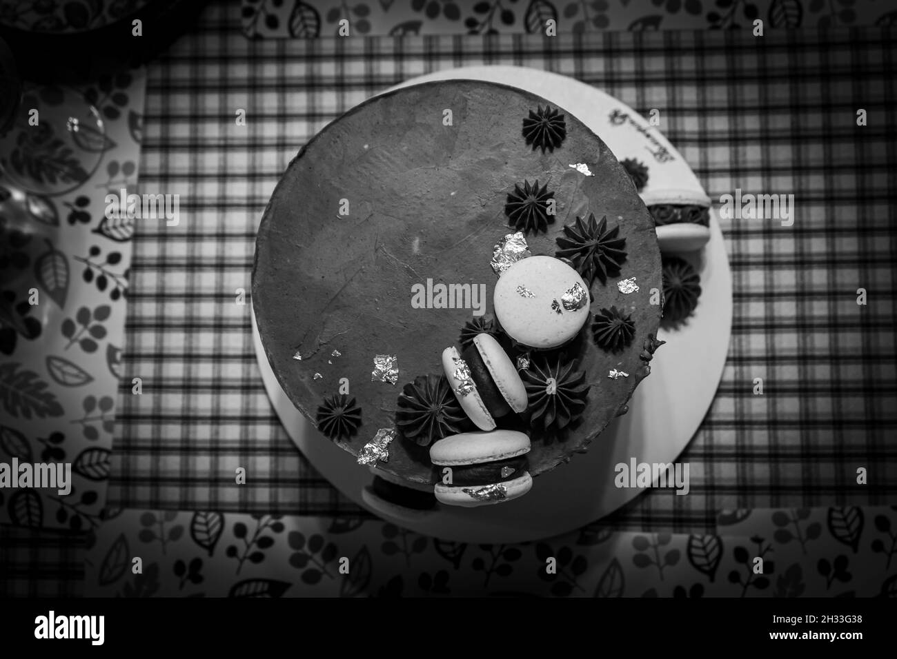 Chocolate cake with macarons, black and white shot Stock Photo