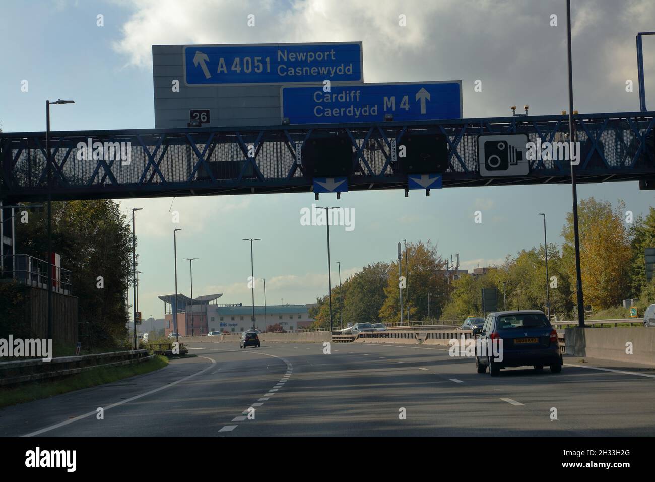 Junction 26 with a lane off to Newport (Casnewydd)  leaving the motorway and signage for the main route. Stock Photo