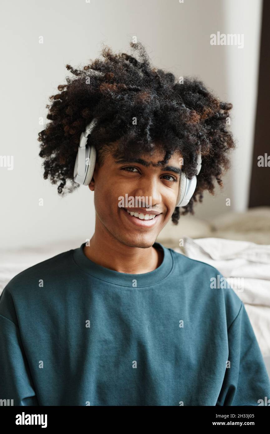 Vertical portrait of smiling AfricanAmerican teenager wearing