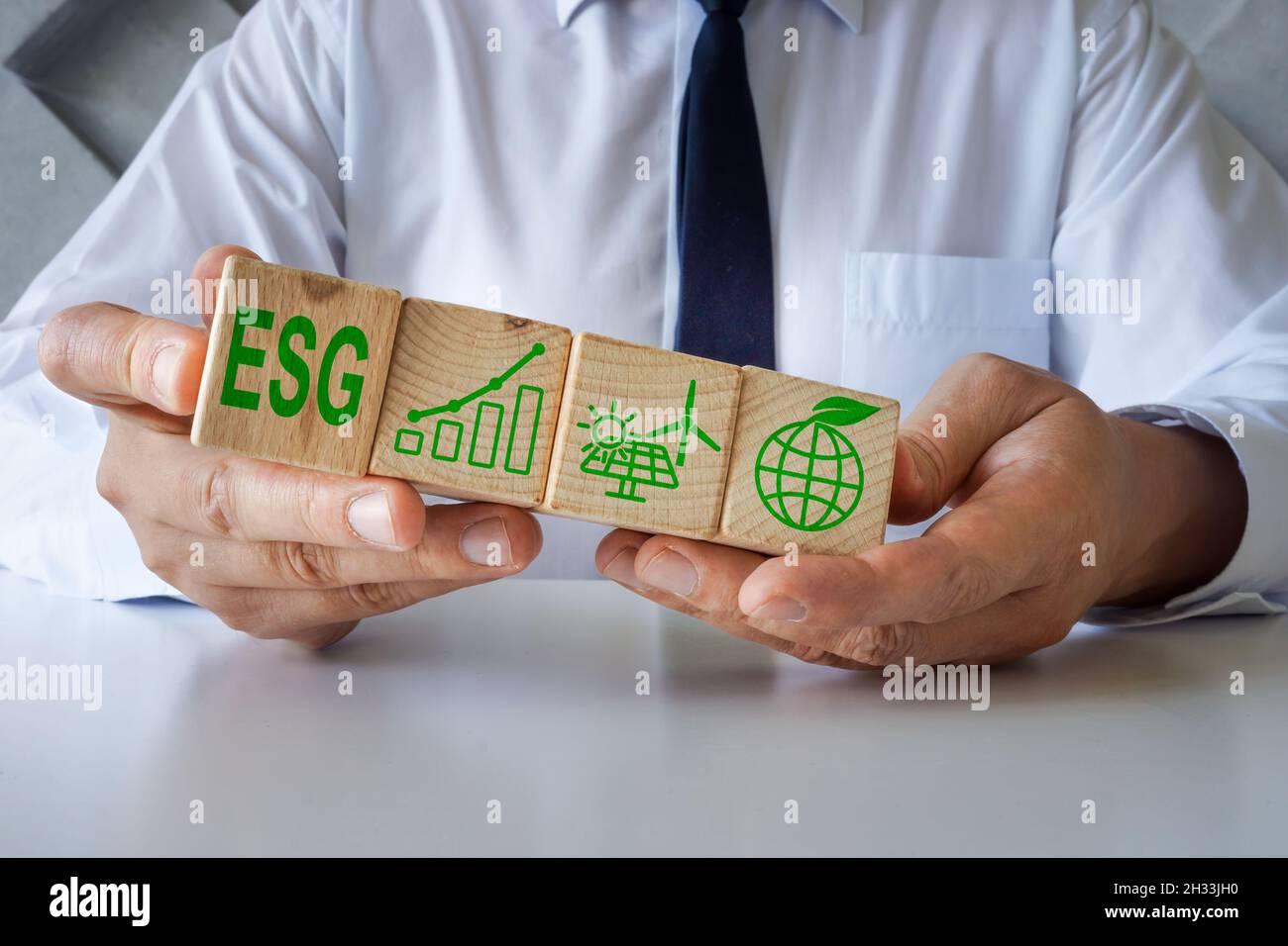 Manager shows cubes with ESG Environmental, Social and Corporate Governance symbols. Stock Photo