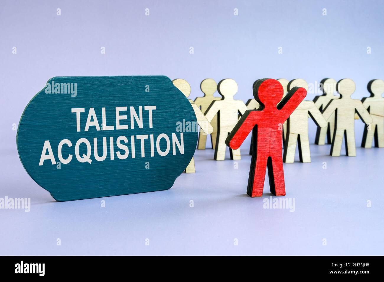 Talent acquisition written on dark plate and wooden figurines. Stock Photo