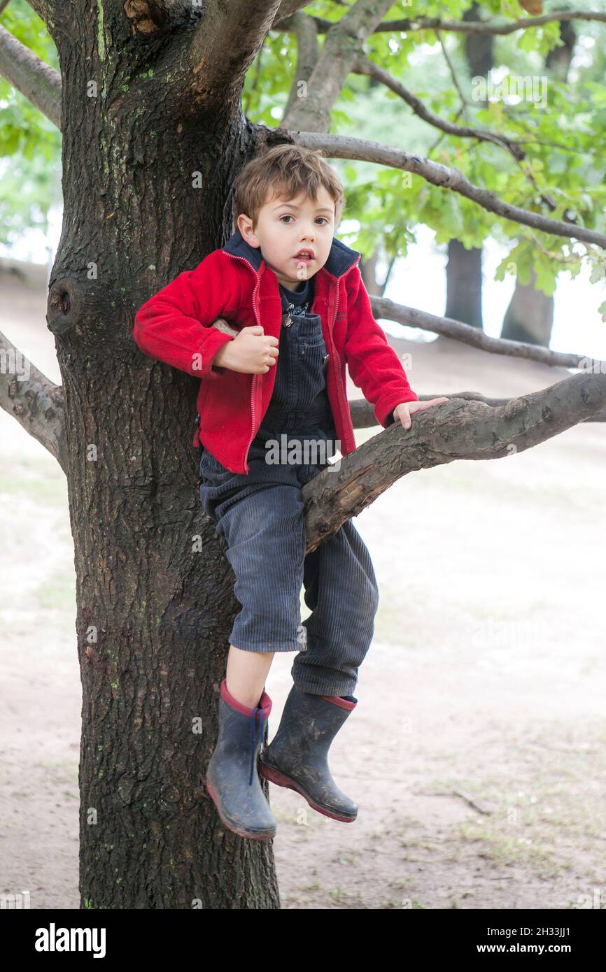 A sevenyearold boy in a red fleece jacket and blue corduroy pants