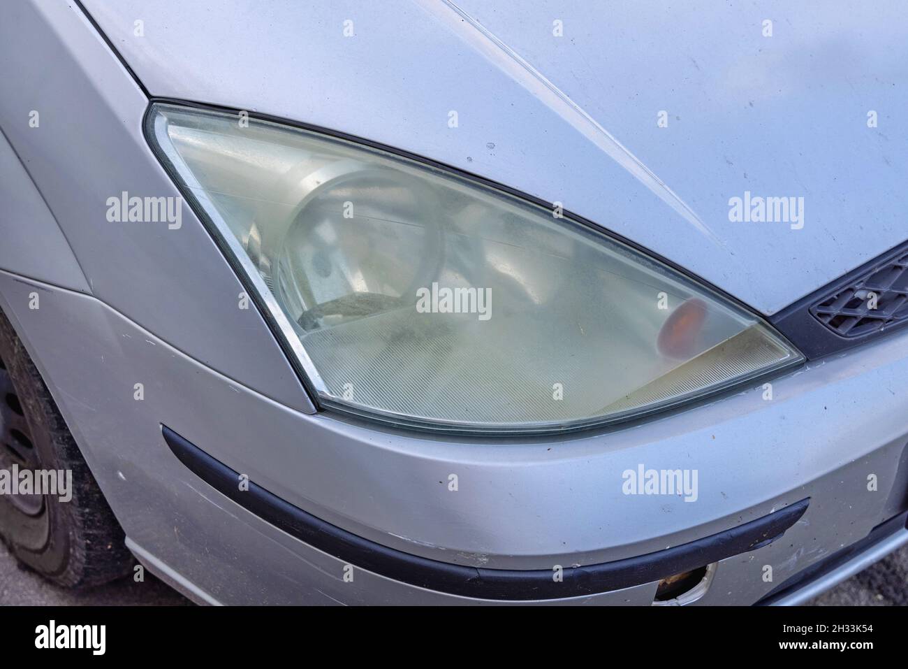 Foggy Headlights Plastic Cover at Old Car Front Stock Photo - Alamy