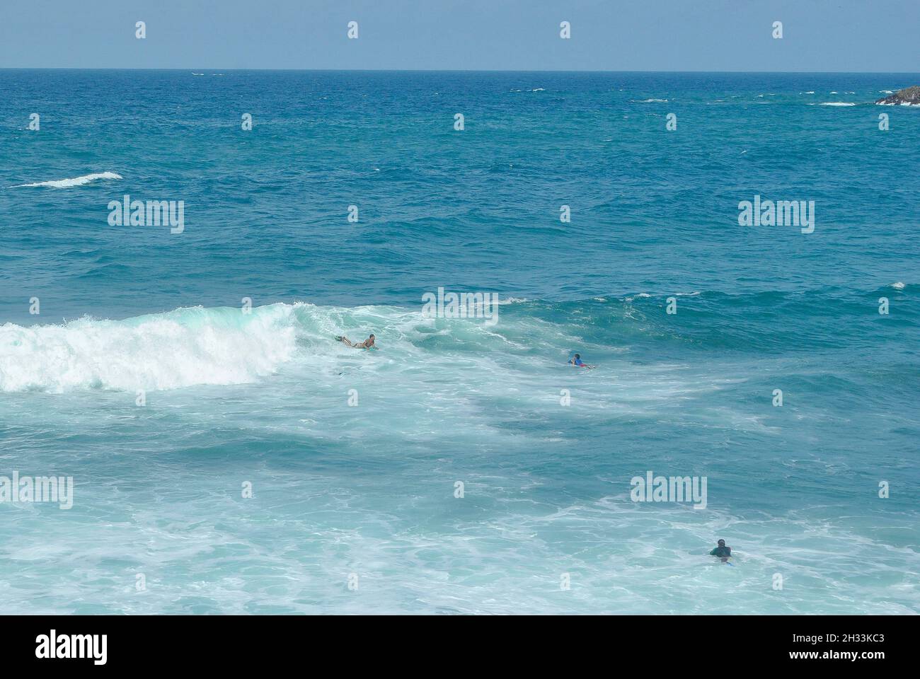 Surfers at the sea.   Salinas beach.  Province of Santa Elena, Ecuador. Stock Photo