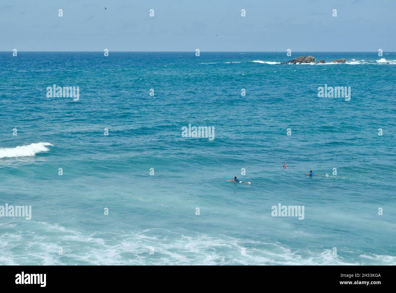 Surfers at the sea.   Salinas beach.  Province of Santa Elena, Ecuador. Stock Photo