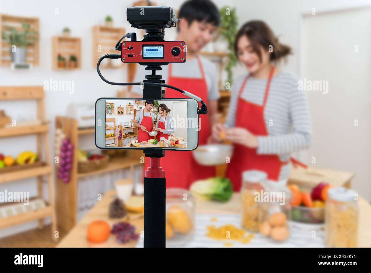 Closeup smart mobile phone taking Live of Happy Asian Lover or couple  cooking in the kitchen room, Camera for photographer or Video and Live  Streaming Stock Photo - Alamy