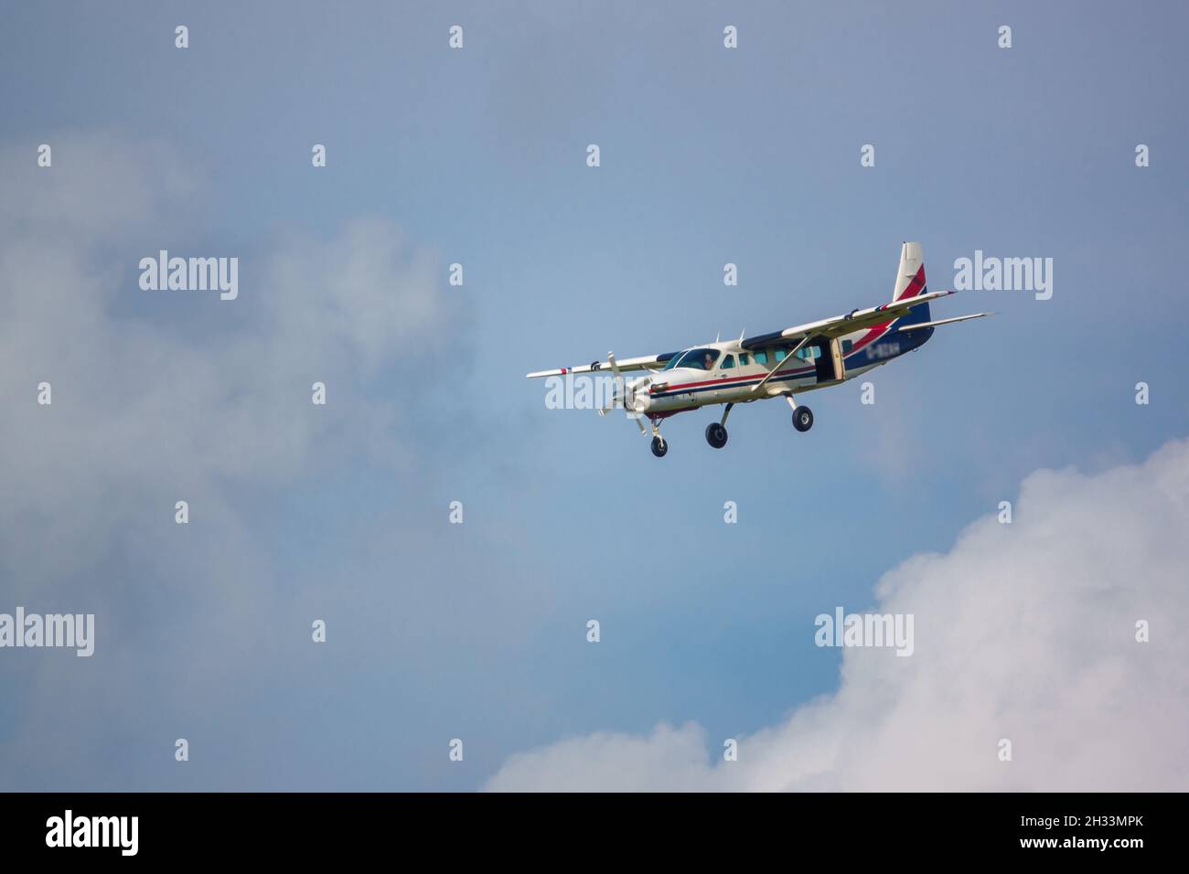 Cessna 208b Grand Caravan G-BZAH light aircraft returning to land after dropping the Red Devils parachute display team on a practice jump, Wilts UK Stock Photo