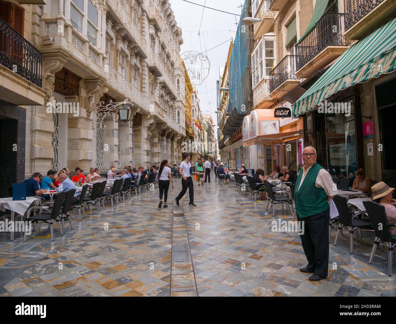 Diners line the street outside restaurants in the Mediterranean city of Cartagena, Spain. Stock Photo