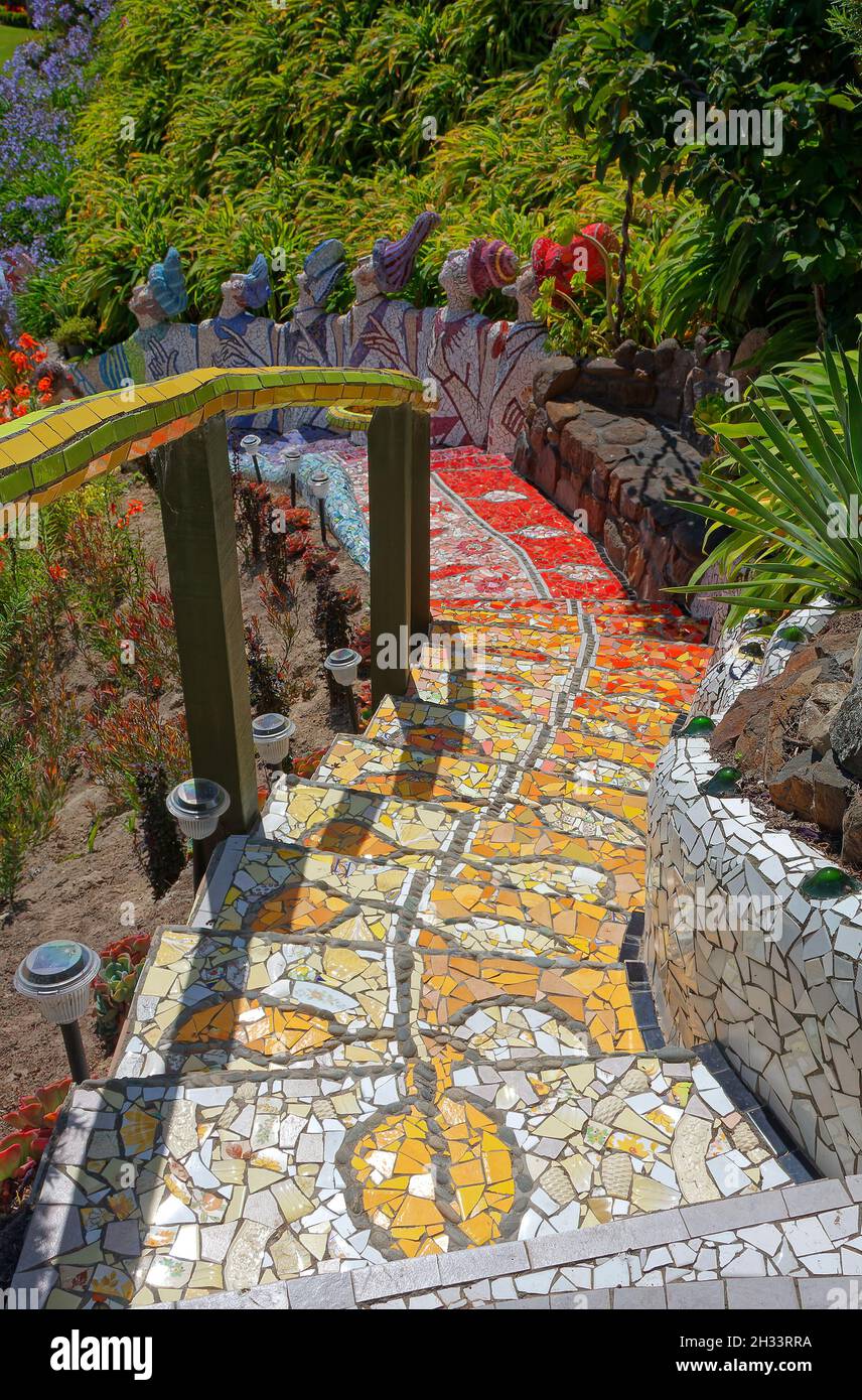 mosaic steps, descending, curved, railing, figures of ladies, shrubs, garden scene, unique, creative, colorful, The Giants House, Akaroa; New Zealand Stock Photo