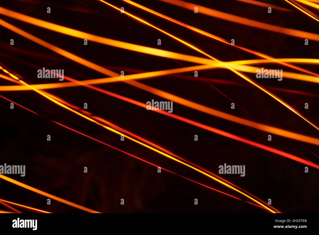 Abstract orange and yellow light lines over black background, modern ...