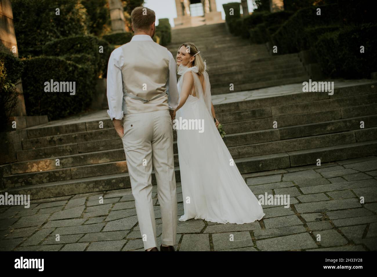 Beautiful young couple walking back hi-res stock photography and images ...