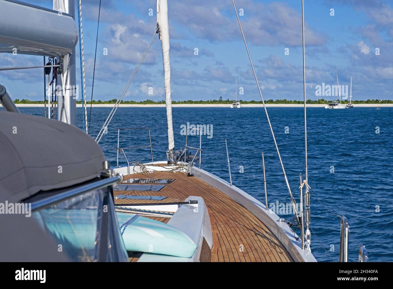 Sailing boat / yacht / sailboat sailing to the small island of Barbuda, part of the country Antigua and Barbuda, West Indies in the Caribbean Sea Stock Photo