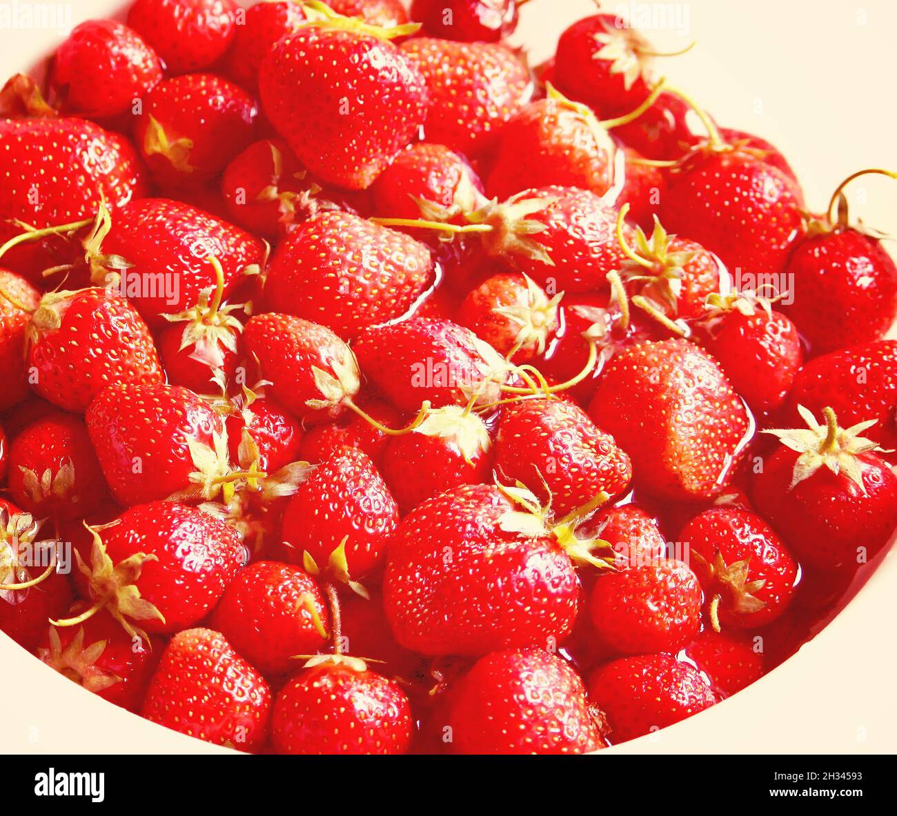 Ripe red strawberries close up on a wooden table outdoors Stock Photo ...