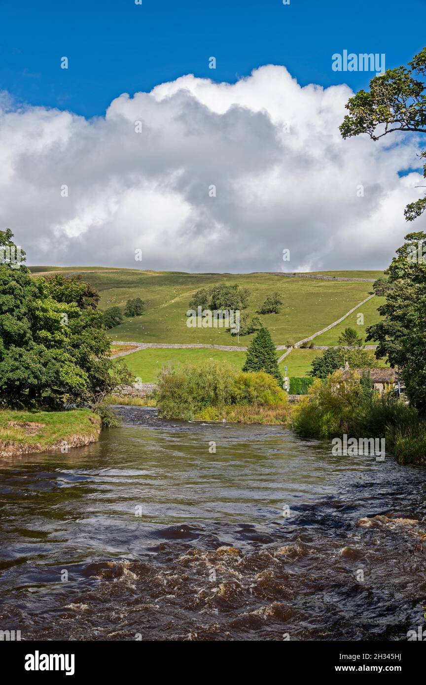 The River Wharfe, flowing past the village of Kettlewell in Upper Wharfedale in the Yorkshire Dales National park, Britain. Stock Photo