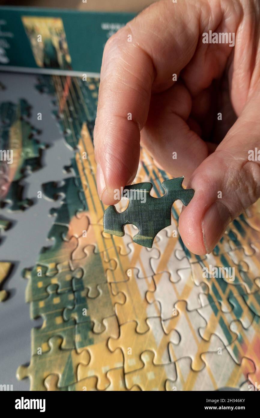 Jigsaw puzzle being assembled Stock Photo