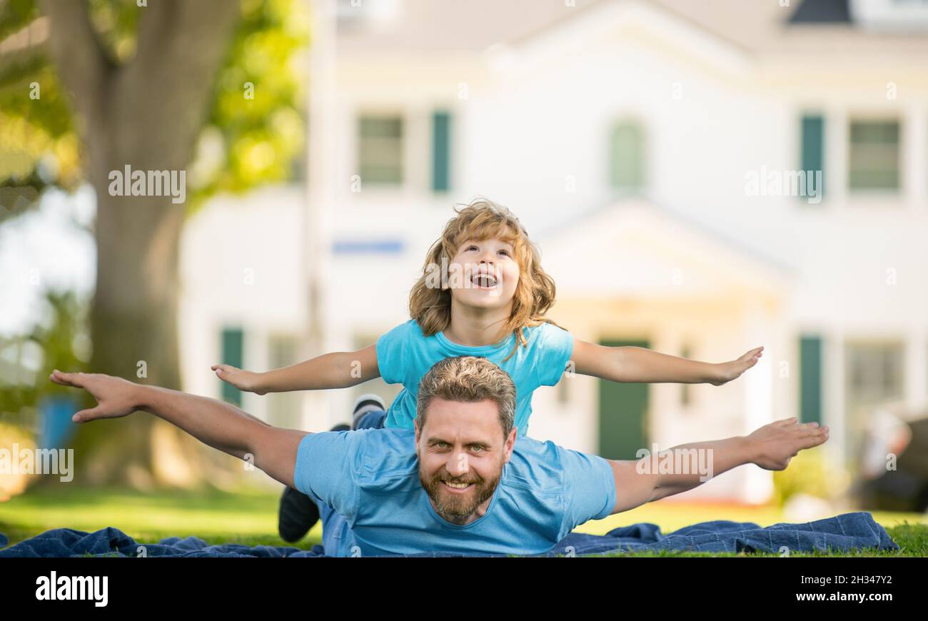 childhood and parenthood. parent spend free time with small child boy on grass. Stock Photo