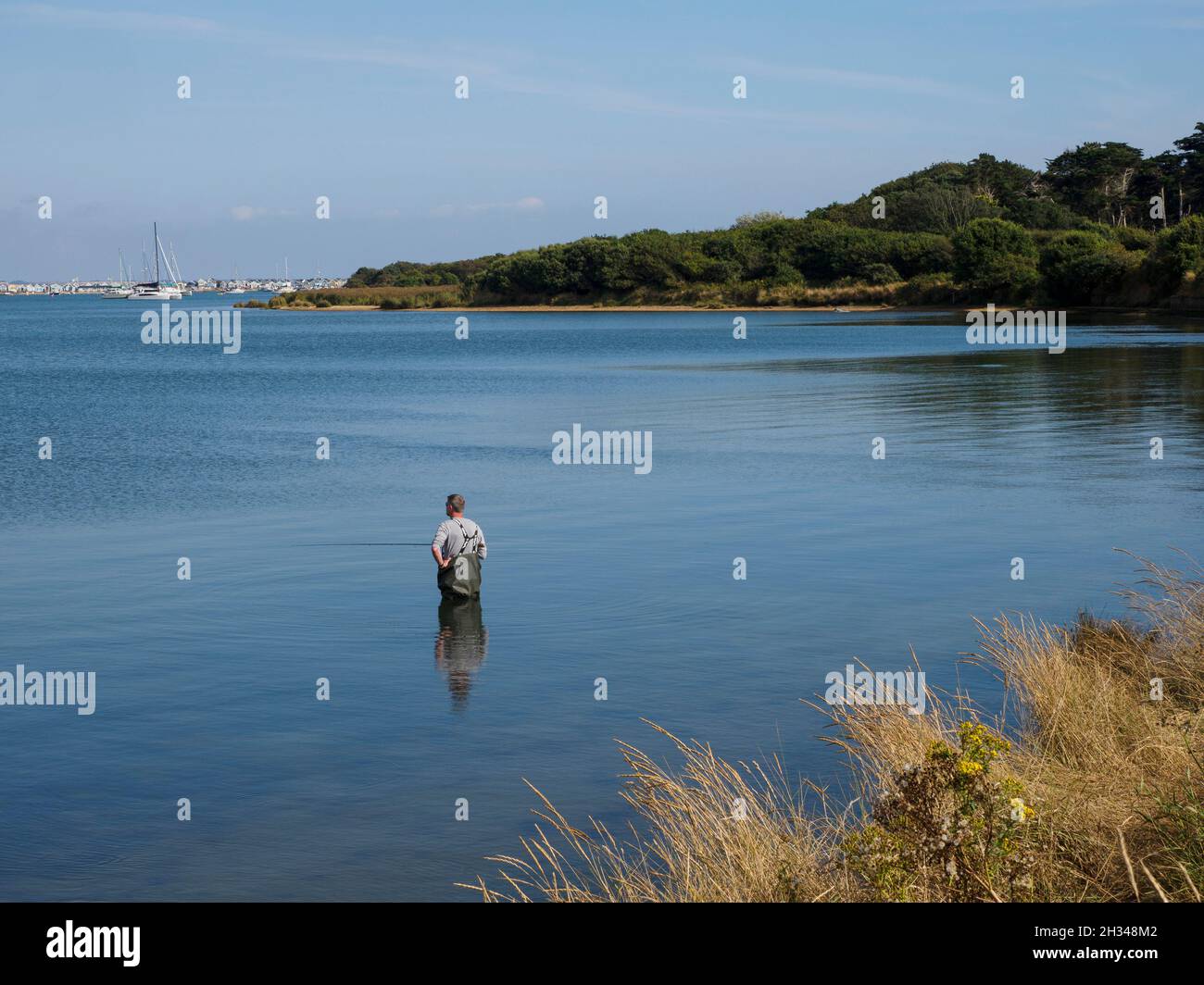 Man fishing in Christchurch Harbour, Dorset, UK Stock Photo Alamy