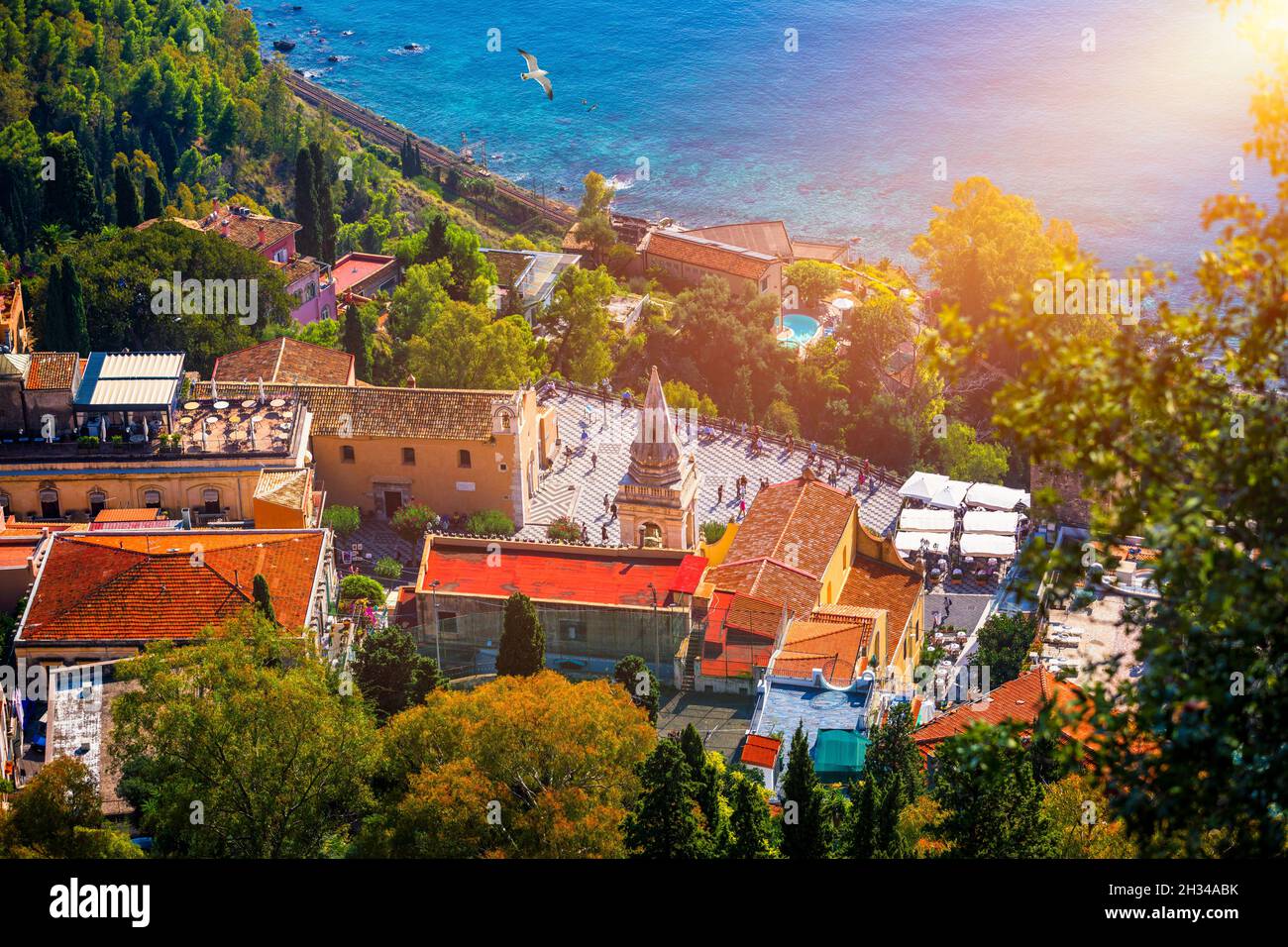 Taormina and San Giuseppe church on the square Piazza IX Aprile in Taormina. Sicily, Italy. Square Piazza IX Aprile with San Giuseppe church and Clock Stock Photo