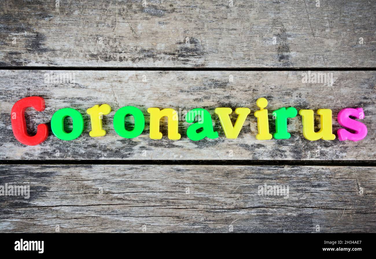 Coronavirus word on wooden desk Stock Photo