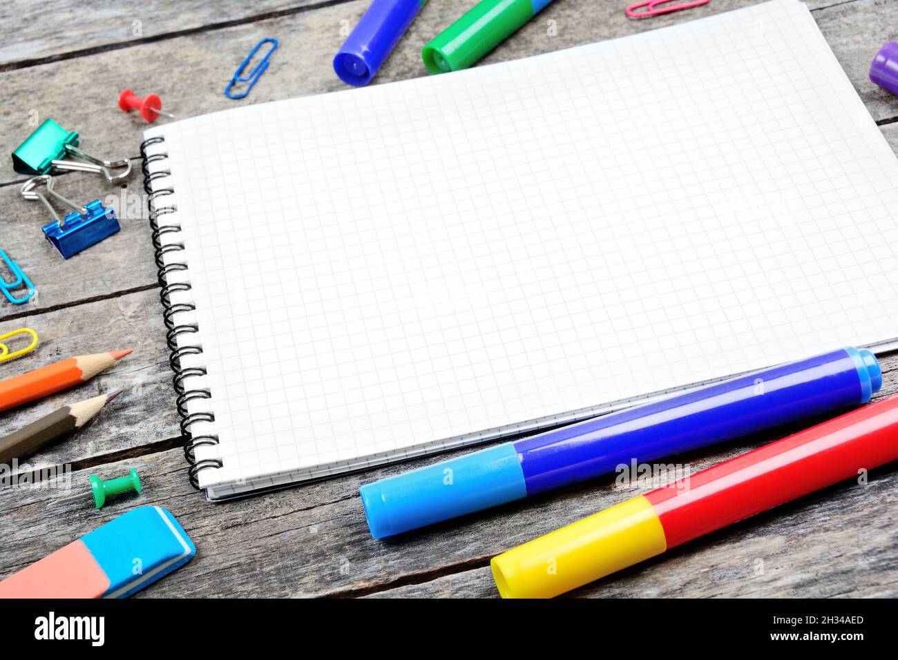 Close up of school supplies with empty notebook on wooden desk Stock Photo