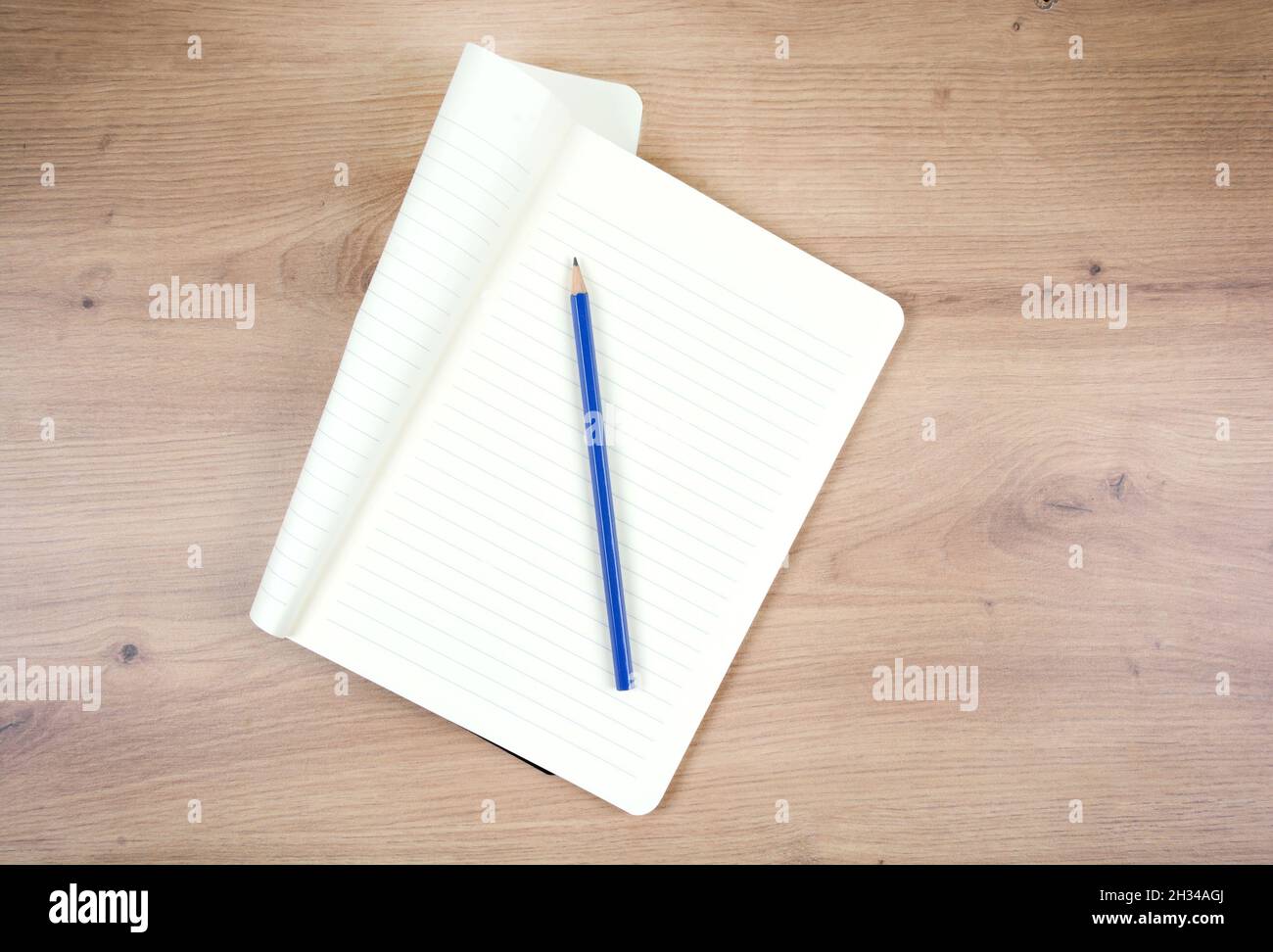 Empty notepad with pencil on wooden table. Top view Stock Photo