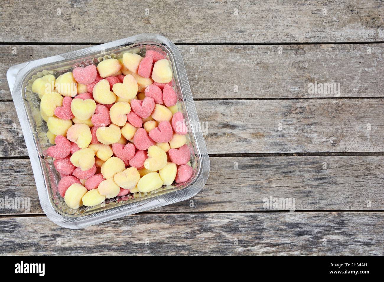 Colorful gnocchi in a plastic receipe on wooden table Stock Photo