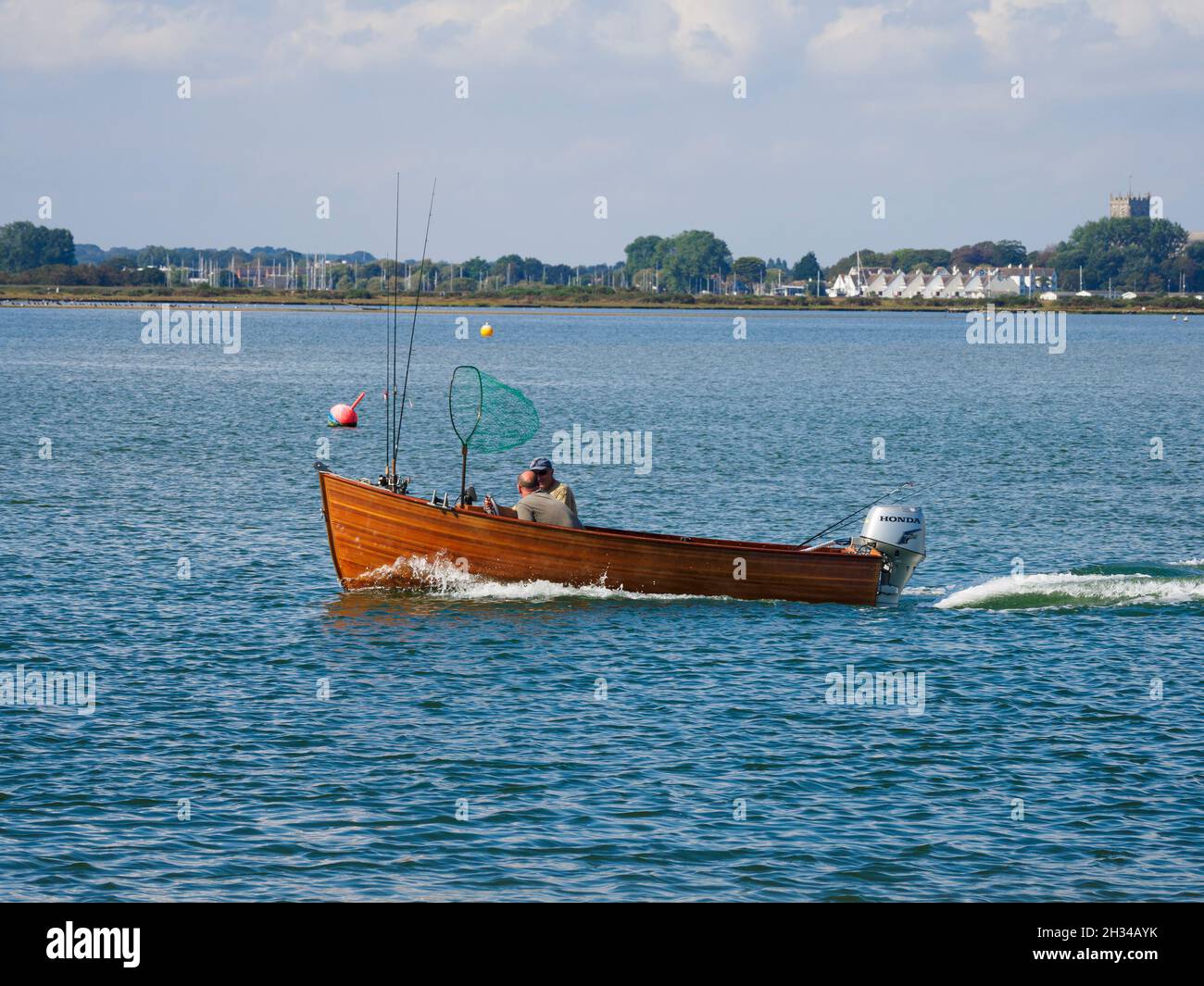 Two men and motor boat going fishing hires stock photography and