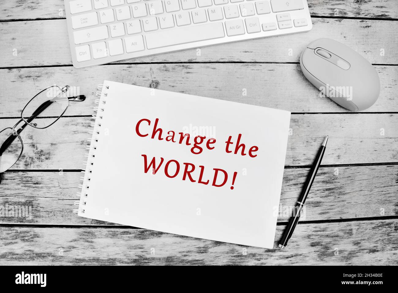 Change the world text on notebook page Stock Photo