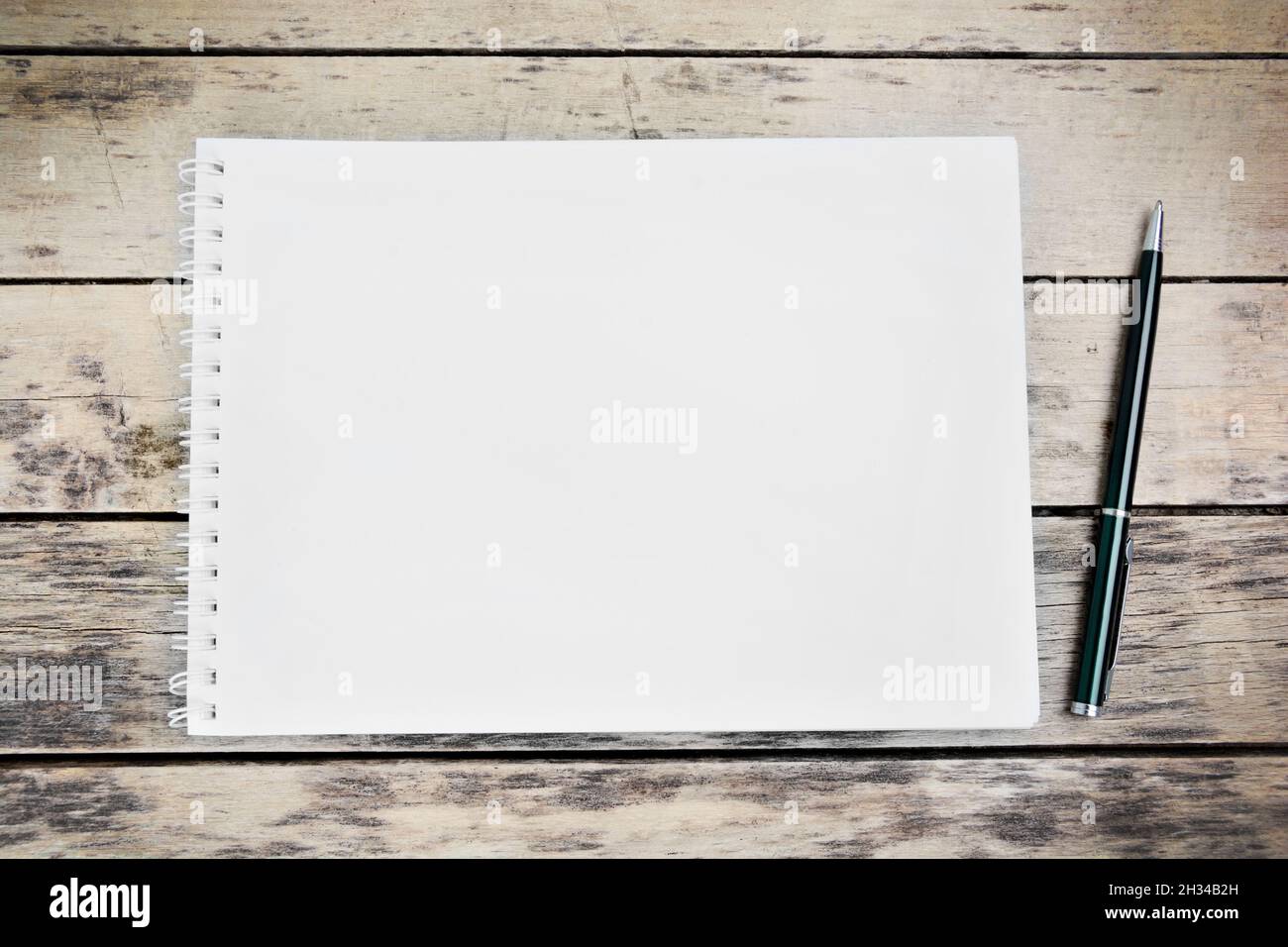 Empty notebook with pen on a wooden desk Stock Photo