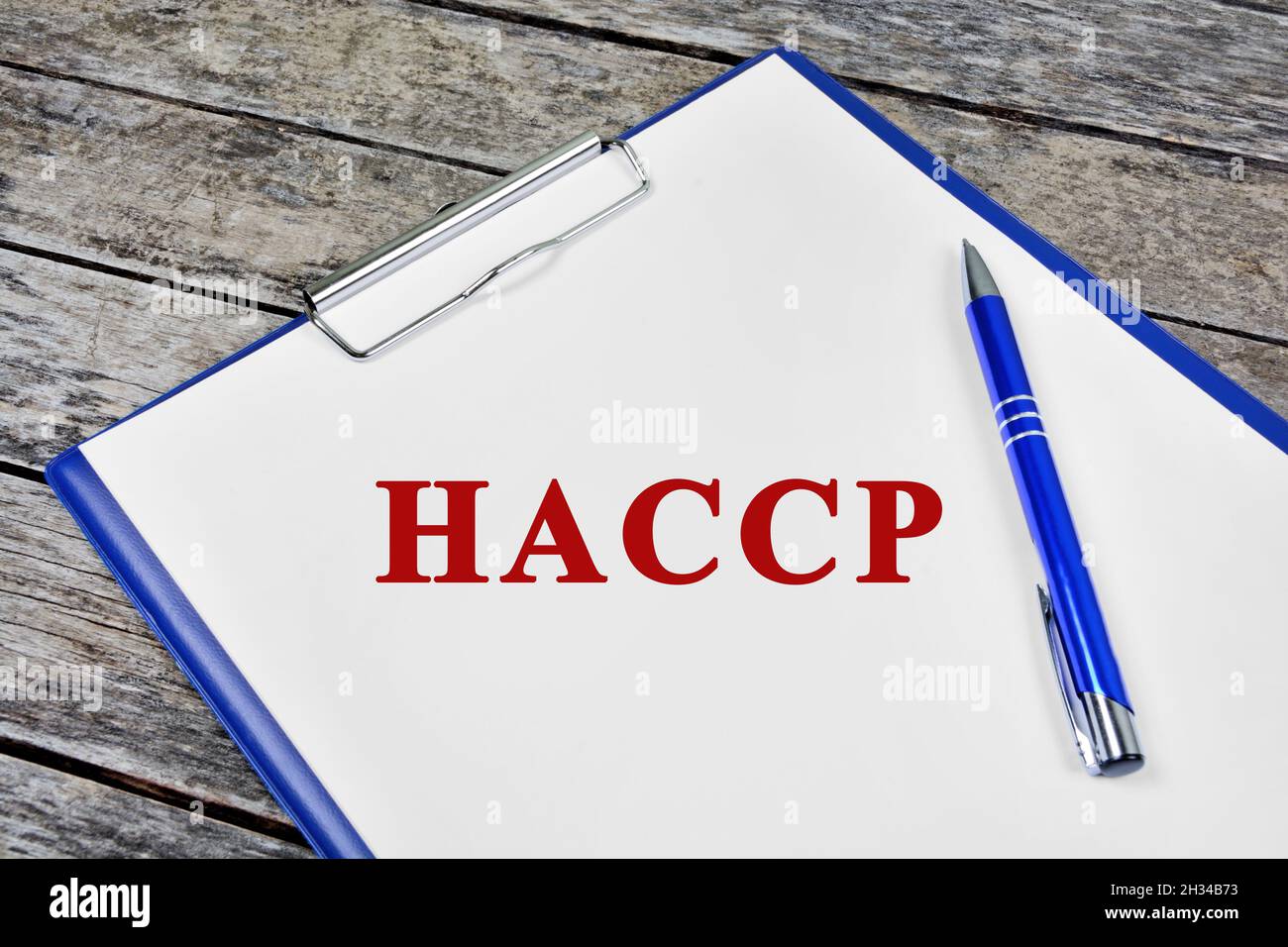HACCP CERTIFIED. Text on white paper on wood background close up Stock Photo