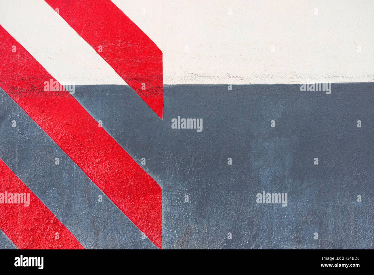Abstract geometric wall texture background. Old white and gray color cement wall painted with diagonal red stripes Stock Photo