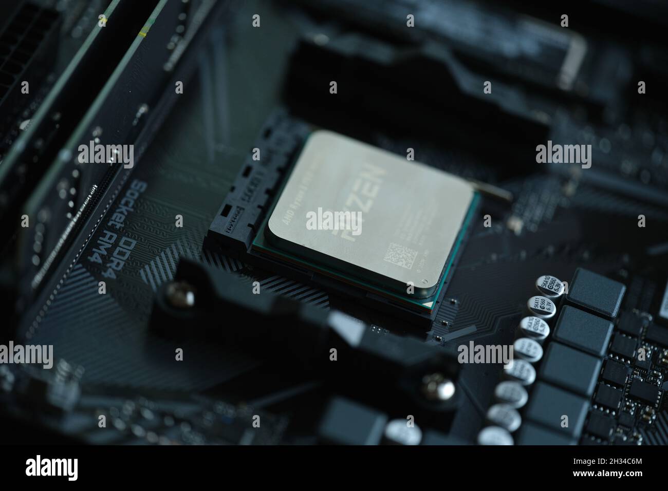 AMD Ryzen processor installed in motherboard slot AM4 closeup Stock Photo