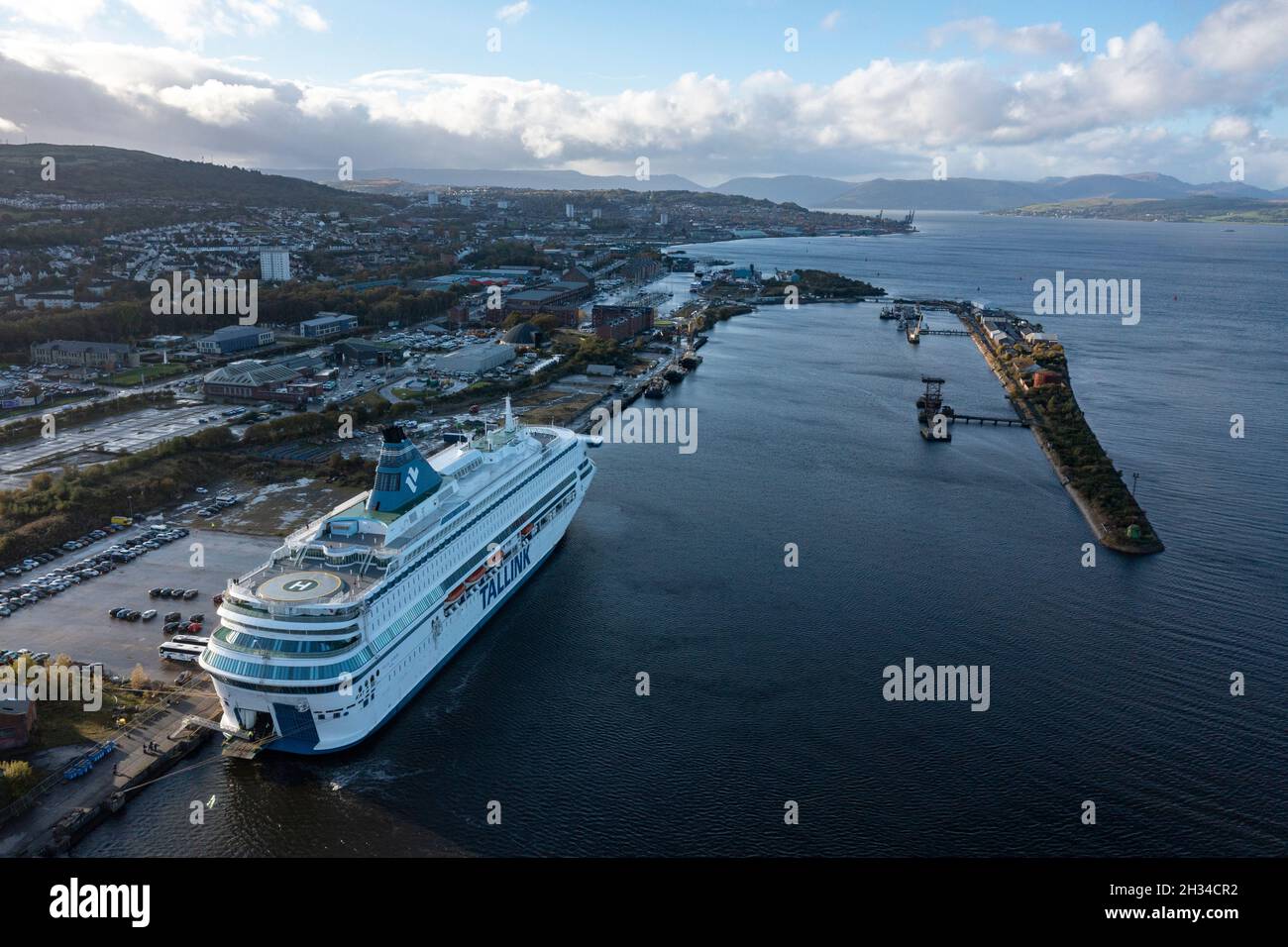 Glasgow, Scotland, UK. 25th Oct, 2021. PICTURED: Aerial drone view of COP26 delegate accommodation in a form of one of two cruise ships which is pictured in Greenock - MS Silja Europa, will provide 3,123 more beds. Shuttle buses will take those on board to and from the summit. The other Tallink's MS Romantika, which has capacity for 2,500 people, has already berthed at King George V dock. Credit: Colin Fisher/Alamy Live News Stock Photo