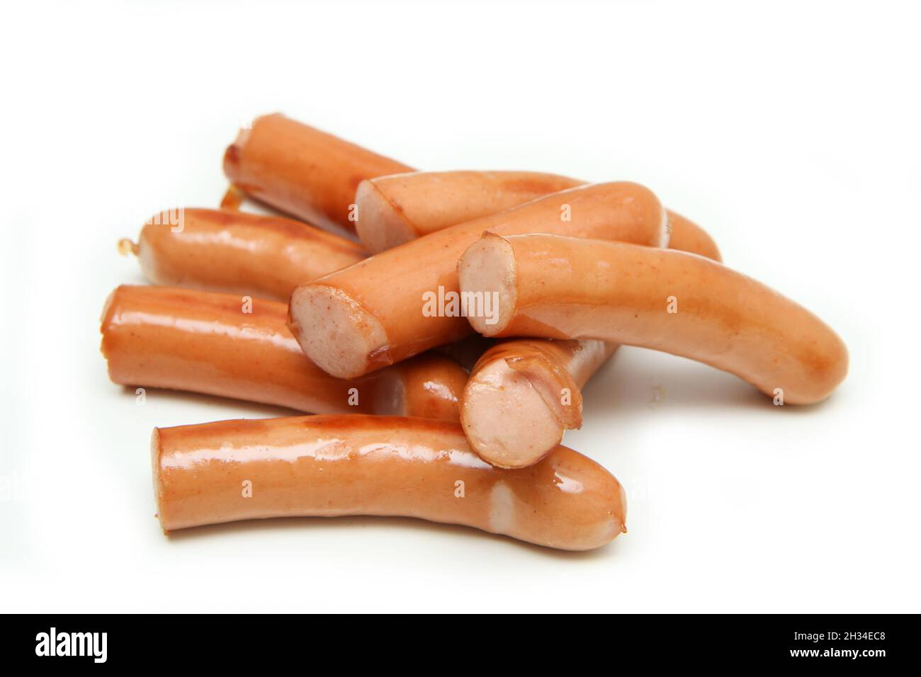 Several roasted greasy wieners isolated in a white background Stock