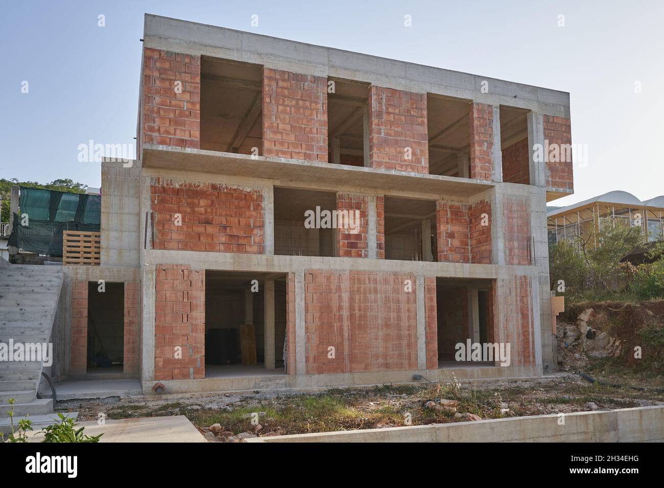 Construction of a modern residential building on a mountainside. Stock Photo