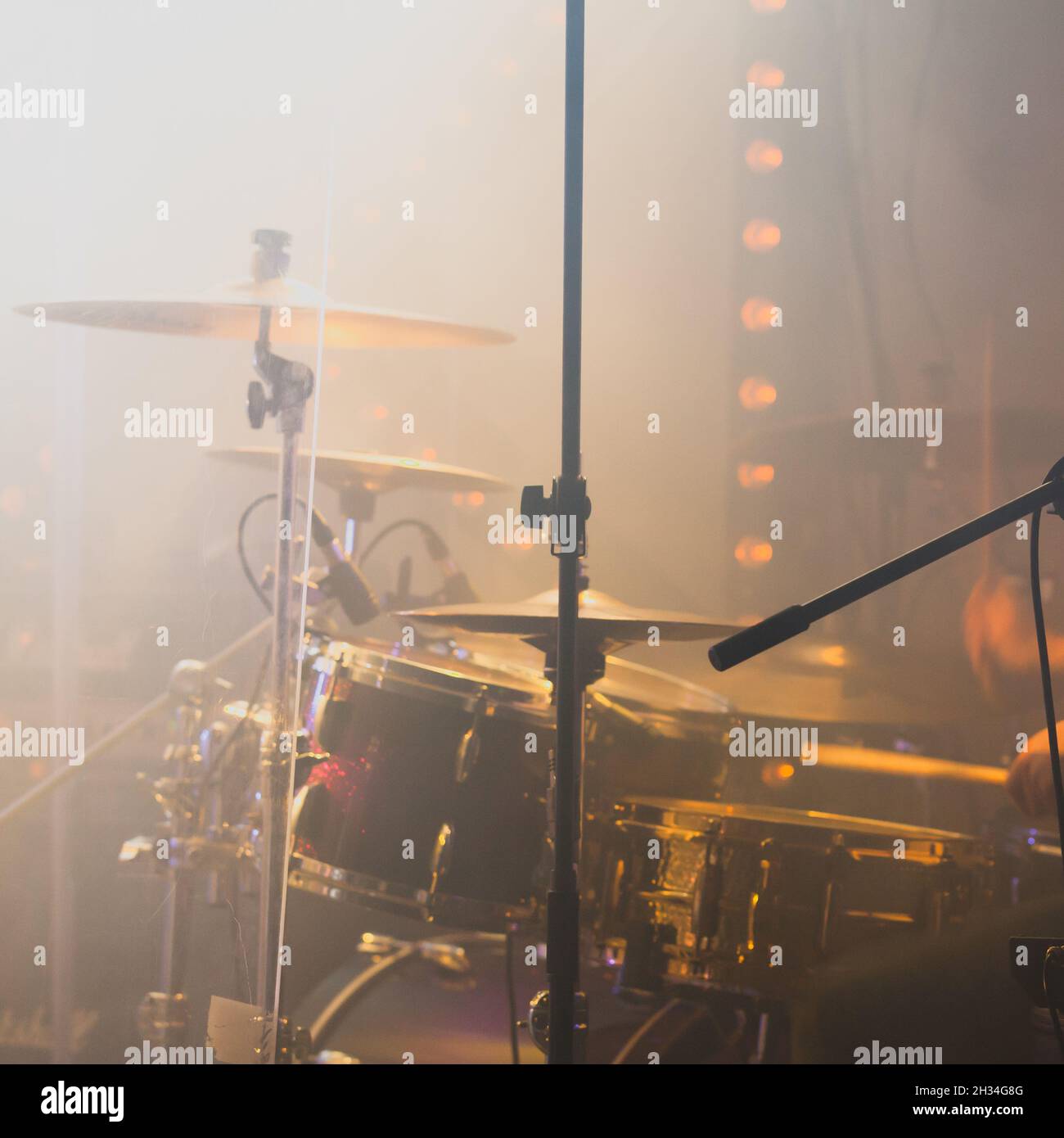 Live rock music photo background, drum set with cymbals in strobe lights. Close-up square photo with soft selective focus Stock Photo