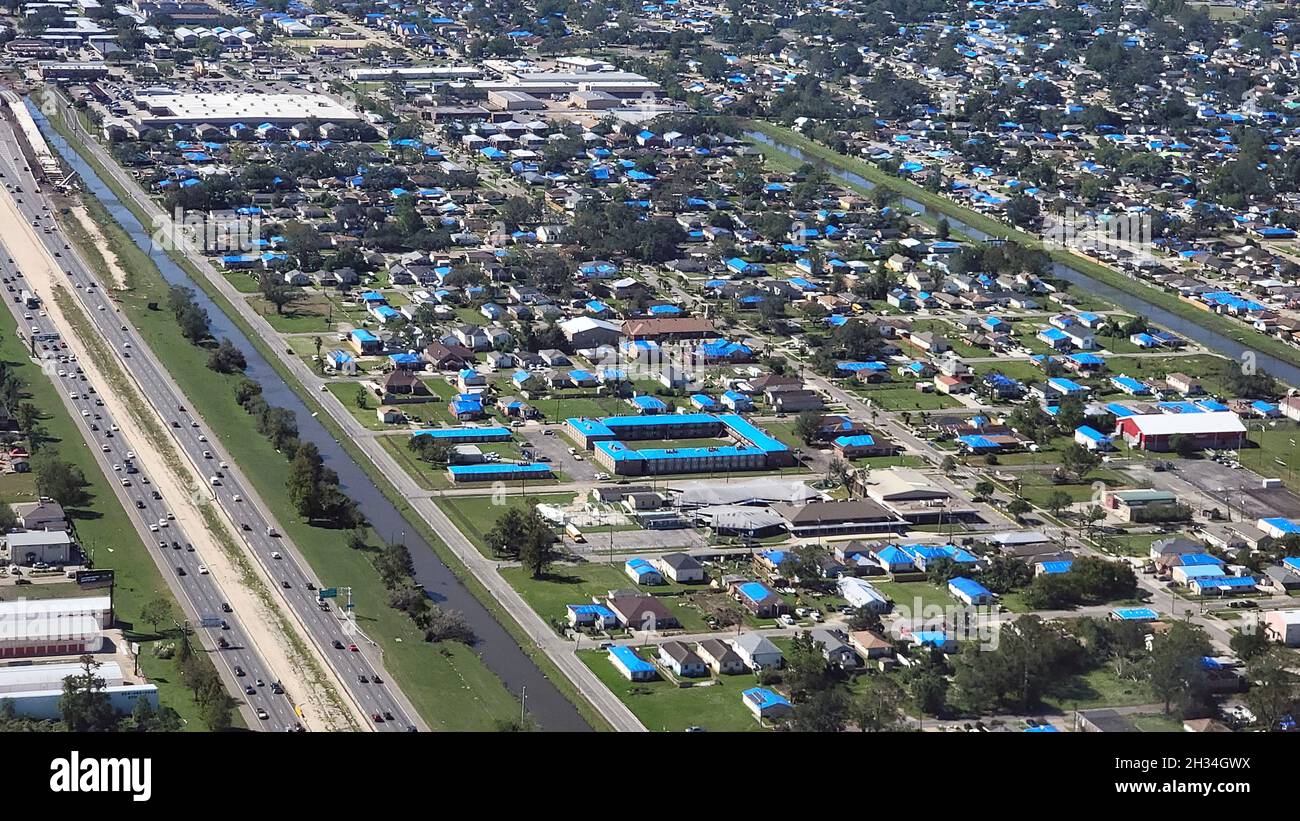 Kenner, United States of America. 16 October, 2021. Aerial view of homes that lost their roofs during Hurricane Ida now covered with blue tarps by FEMA and the U.S. Army Corps of Engineers during Operation Blue Roof October 16, 2021 in Kenner, Louisiana. Eligible homeowners are provided with temporary roof repairs to secure their property until proper repairs can be performed. Credit: Brooks Hubbard/U.S. Army Corps of Engineers/Alamy Live News Stock Photo