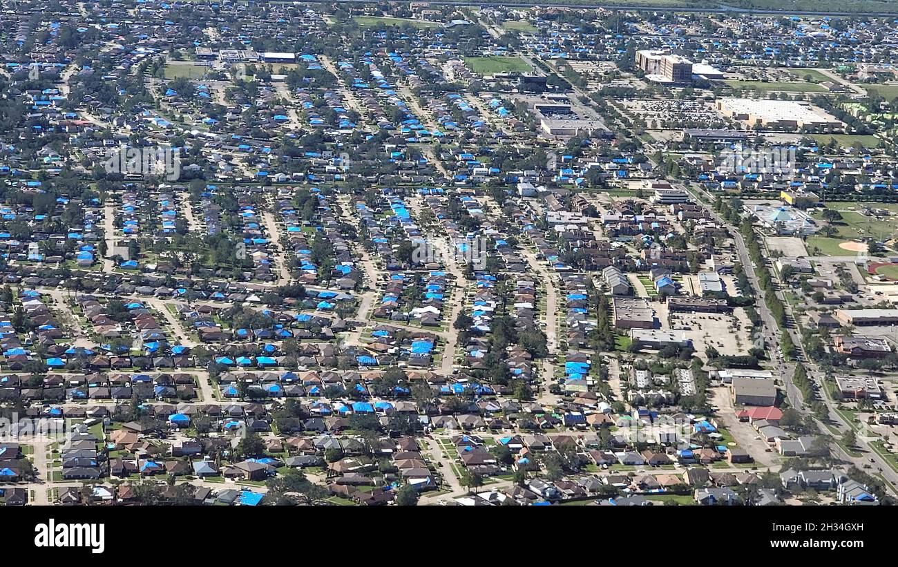 Kenner, United States of America. 16 October, 2021. Aerial view of homes that lost their roofs during Hurricane Ida now covered with blue tarps by FEMA and the U.S. Army Corps of Engineers during Operation Blue Roof October 16, 2021 in Kenner, Louisiana. Eligible homeowners are provided with temporary roof repairs to secure their property until proper repairs can be performed. Credit: Brooks Hubbard/U.S. Army Corps of Engineers/Alamy Live News Stock Photo