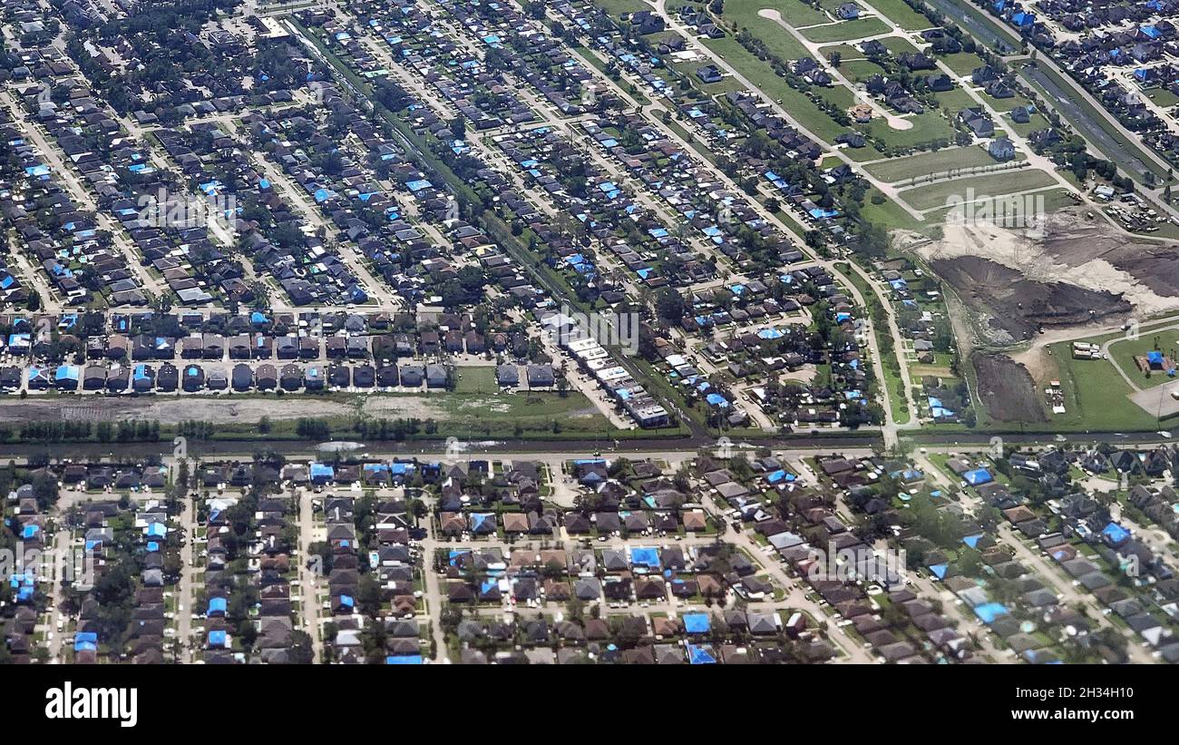 Kenner, United States of America. 16 October, 2021. Aerial view of homes that lost their roofs during Hurricane Ida now covered with blue tarps by FEMA and the U.S. Army Corps of Engineers during Operation Blue Roof October 16, 2021 in Kenner, Louisiana. Eligible homeowners are provided with temporary roof repairs to secure their property until proper repairs can be performed. Credit: Brooks Hubbard/U.S. Army Corps of Engineers/Alamy Live News Stock Photo