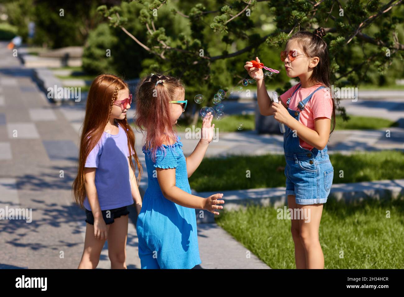 kids playing with soap bubbles in the park Stock Photo - Alamy