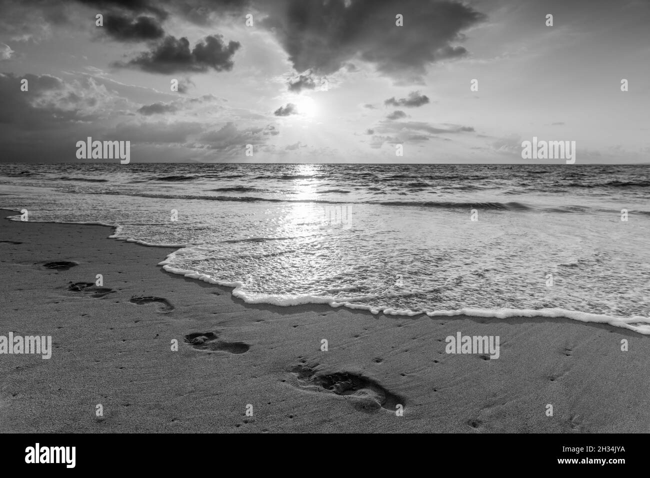 Footprints In The Sand Ocean Sunset In Black And White Image Format Stock Photo